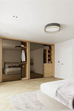 an empty bedroom with closets and bed in it