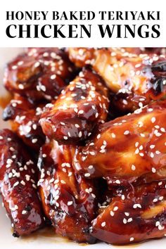 honey - baked teriyaki chicken wings with sesame seeds on top and in the middle