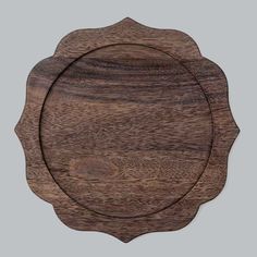 a wooden plate with a circular design on the front and side, made out of wood