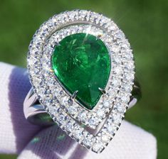 A Breathtakingly Striking  HANDMADE 14k White Gold Ring with Beautiful Pear Cut Tsavorite in Green color! The GEM is 5.24 CT and measures 13.22x9.73x5.34 mm! This Stone will take your breath away, especially on the sunlight! You will want to look at this stone endlessly. The mounting is a masterpiece! HANDMADE 14K White Gold Mounting (tested), that was is custom made to Accommodate this Beauty of a Gem in Prongs setting! Super FINE Workmanship on the Diamond prong  setting with 54 pcs Brilliant Full Cut Diamonds in GH color, SI1 clarity, totaling to approx 0.84 ct! Fabulous Braided Band and Diamond Gallery! The Entire Top's outline is 24.9x18.0 mm- HUGE. The Ring weights 8.5 g, nice and SOLID. Sits 6.7 mm off the top of the finger. Finger size 7 (Free Re-sizing with purchase). Center Stone Gia Certified Green Gemstones For Anniversary, Gia Certified Green Gemstones, Gia Certified Fine Green Gemstones, Gia Certified Green Gemstones Fine Jewelry, Gia Certified White Gold Tsavorite Rings, Gia Certified Green Pear-shaped Rings, Gia Certified Green Pear-shaped Diamond Ring, Gia Certified Pear-shaped Green Emerald Ring, Luxury Green Tsavorite Diamond Ring