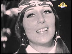 an old photo of a woman wearing a bandana and smiling at the camera with words on it