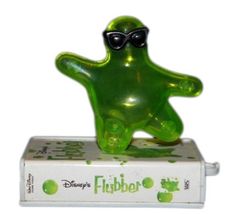 a green frog figurine sitting on top of a box