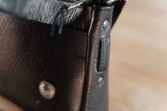 the inside of a black leather purse on a wooden table