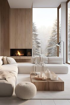 a living room filled with white furniture and a fire place in the middle of it