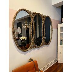 three mirrors are hanging on the wall near a couch