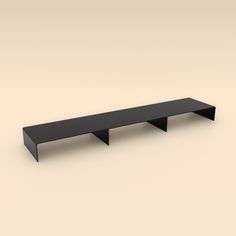 a black shelf sitting on top of a white floor next to a brown wall with no one in it