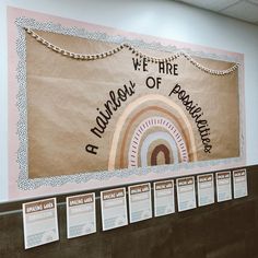 a bulletin board in the middle of a room with information about rainbows on it