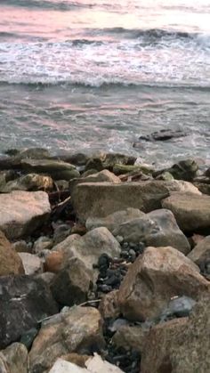 rocks on the beach with water in the background