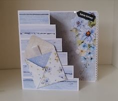 a card with an envelope and flowers on it