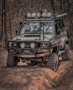 an off - road vehicle is driving through the mud