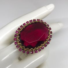 Badgley Mischka Ring With Massive Stone Surrounded By Fuchsia Crystals . If You Are Searching For A Statement Ring - This Is The One . Comes With A Tag Attached . Never Worn . In Very Good Condition . Party Ruby Ring, Ruby Party Ring, Ruby Ring For Party, Round Shape, Ruby Ring For Parties, Party Ruby Ring Round Shape, Party Ruby Gemstone Rings, Pink Jeweled Rings For Party, Pink Jeweled Party Rings, Pink Jeweled Wedding Ring