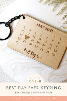 a wooden keychain with the date on it that says, best day ever keyring