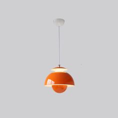 an orange and white light hanging from a ceiling