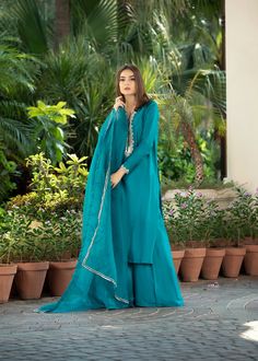 • Turquoise rawsilk handworked shirt with work on neckline (front and back) and sleeves with zardozi and dabka • Paired with matching rawsilk flared pants • Add on a pure katan organza dupatta with gota on four sides (Includes Shirt and pants) Turquoise Sharara With Resham Embroidery For Eid, Elegant Turquoise Set With Dupatta, Turquoise Kurta With Dabka Work For Eid, Turquoise Resham Embroidered Kurta For Eid, Turquoise Kurta With Resham Embroidery For Eid, Turquoise Resham Embroidery Kurta For Eid, Turquoise Dabka Work Sets For Eid, Eid Turquoise Kurta With Resham Embroidery, Eid Turquoise Kurta With Dabka Work