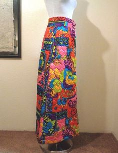 "Fabulous unique vintage 60s to 70s mod skirt. Bold psychedelic floral pattern on quilted acetate. Gold buttons close the front. Wide waist band. Lined in purple acetate. Excellent vintage condition. Label: just content and origin label Material: acetate Color: red, pink, green, blue, purple, golden yellow Size: Small Waist Size: 26\" Waist to Hem: 39.5\" Bottoms Size (Women's): S Hip Size: 44\" Excellent vintage condition" Hippie Multicolor Floral Print Skirt, Vintage Multicolor Skirt, Vintage Multicolor Skirt For Festival, Vintage Patchwork Skirt For Festival, Multicolor Retro Festival Skirt, Retro Multicolor Festival Skirt, Mod Skirt, 70s Mod, Peter Max