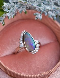 In ancient Rome, it was believed that opal brings love and hope. We have no doubt that it’s exactly the gem that symbolizes a strong alliance. We have created a custom engagement opal ring with diamonds for those who value love and reliability in the relationship. Creating the unique design of the ring we wanted to combine two symbols: infinity and Yin Yang, which are so meaningful for engagement rings.The best addition to dream ring is white gold and sparkling diamonds that give goddess ring a Opal Diamond Engagement Ring, Black Opal Engagement Ring, Unique Opal Ring, 14k Gold Opal Ring, Goddess Ring, Opal Promise Ring, Montana Sapphire Engagement, Montana Sapphire Engagement Ring, Gold Opal Ring