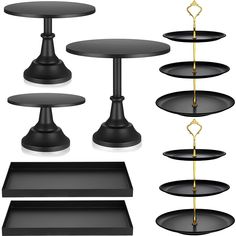 an assortment of black tables and trays with gold chains hanging from the top, on white background