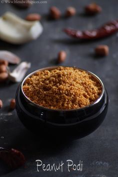 a bowl filled with food sitting on top of a table next to garlic and other ingredients