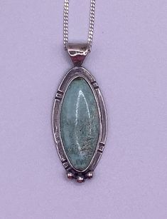 "Turquoise from Nevada and Sterling Silver pendant.  The color in this piece is a slight blue-green color. Slight inclusions lend to the authenticity of this turquoise piece.  It measures approximately 1-1/2\" height including the bail x 1/2\" wide.  This piece comes with an 18\" sterling silver chain" Artisan Green Turquoise Necklace With Large Pendant, Turquoise Pendant Necklace With Patina, Collectible Blue Turquoise Necklace With Large Pendant, Blue Turquoise Necklace With Large Pendant, Green Turquoise Pendant Necklace With Large Stone, Oval Turquoise Necklace With Patina, Collectible Green Turquoise Pendant Necklace, Collector's Turquoise Necklace With Round Pendant, Collectible Turquoise Necklace With Round Pendant