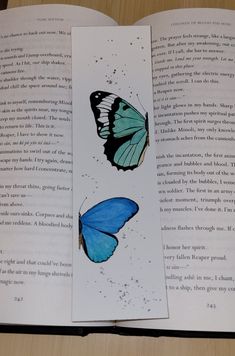 an open book with two butterflies on it