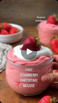 a person is holding a strawberry cheesecake mousse