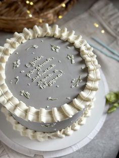 a birthday cake with white frosting and decorations