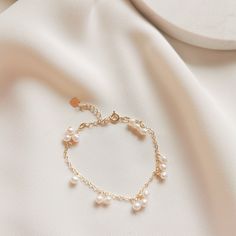 DAINTY BRACELET | DELICATE PEARL BRACELET | DAINTY ANKLET | FRESHWATER PEARL BRACELET | 14K GOLD FILLED PEARL BRACELET | STERLING SILVER PEARL BRACELET | WHITE PEARL GOLD BRACELET | BRIDAL BRACELET | GOLD BRACELET |  Julie Small Pearl Bracelet 🤍 S T Y L E 🤍 * small freshwater pearls with 14k gold-filled or 925 sterling silver chain bracelet. * The matching necklace version here👉: https://www.etsy.com/au/listing/1454534234 * The matching earrings version here👉:  🤍 M E A S U R E M E N T S 🤍 * Length Bracelet: total approx. 15cm + 5cm extender * Pearl size approx. 3-4mm  🤍 M A T E R I A L S 🤍 * Pearl Freshwater Pearl * Metal Yellow Gold: 14k gold-filled  Silver: 925 Sterling Silver 🤍 P E R S O N A L I S E D 🤍 If you wish to have your jewelry made with other shapes or numbers of pear Pearl Crystal Bracelet With Pearl Charm As Gift, Elegant Pearl Beaded Charm Bracelet, Elegant Charm Bracelet With Pearl And Round Beads, Round Pearl Bracelets With Pearl Drop, Pearl Bracelets With Pearl Drop, Pearl Bracelet With Pearl Drop, White Pearl Bracelet With Adjustable Chain, Pearl Drop Bracelet Jewelry, Adjustable Pearl White Bracelet With Pearl Chain