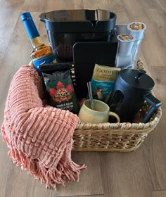 a wicker basket filled with coffee, tea and other items on a wooden floor