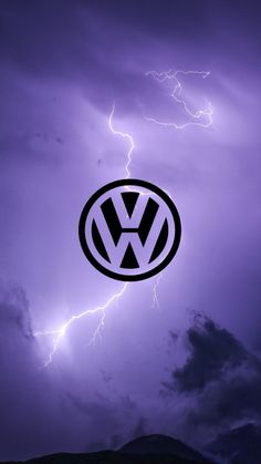 the vw logo is shown in front of a lightning storm with purple clouds behind it