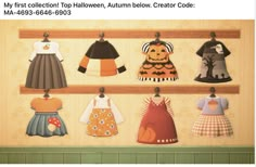 a group of children's clothing hanging on a wooden shelf in front of a wall