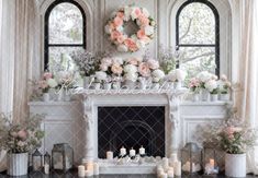 a fireplace with flowers and candles in front of it