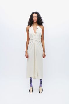 White wild silk halter dress, featuring a halter neck and open back. Self ties at neck and waist belt. Multiple ways of wrapping and wearing. Spring Formal Halter Neck Dress, Halter Neck Midi Dress With Tie Back For Evening, Silk Halter Neck Dress With Tie Back, Chic Silk Halter Midi Dress, Chic Silk Midi-length Halter Dress, Elegant Halter Dress With Tie Back For Casual Wear, Elegant Halter Dress With Tie Back For Casual Events, Formal Summer Halter Dress With Tie Back, Chic Backless Halter Dress For Casual Wear