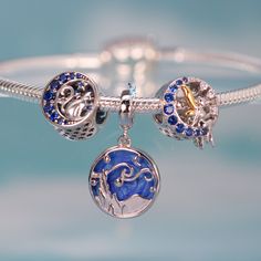 This is charm only, bracelets are sold separately. Experience the allure of Van Gogh's iconic "Starry Night" every day with this exquisite dangle charm. Featuring a stunning blue sky and a silhouette landscape design, this charm is the perfect addition to any bracelet or gift for a loved one. Don't miss out on the chance to own this unique piece inspired by one of the most famous paintings in the world! Materials: 925 sterling silverFinish: platinum plate, enamelDimensions: 0.85 x 0.51 inHole size: 0.18 in Jewelry Care: See more information about how to care for your jewelry here. Shipping Policy: Orders will be shipped within 1-3 business days. Economy shipping will take 7-14 days to arrive and standard shipping is 1- 4 days for U.S. orders. International shipping time is depended on the Celestial Sterling Silver Charms Jewelry, Celestial Sterling Silver Jewelry With Dangling Charms, Celestial Jewelry With Dangling Charms In Sterling Silver, Blue Star Charm Round Pendant Jewelry, Blue Round Pendant Jewelry With Star Charm, Blue Sterling Silver Charms For Gifts, Silver Dangle Moon Charm, Nickel-free Blue Sterling Silver Charm Bracelet, Blue Jewelry With Removable Charms For Gift