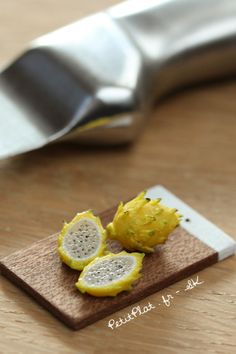 two pieces of fruit sitting on top of a cutting board