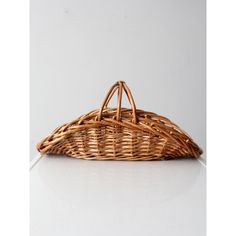 a wicker basket sitting on top of a white table