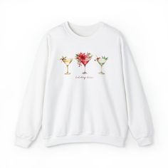 This chic and glam sweatshirt is perfect to wear during the holiday season. Three gorgeous Christmas cocktails and the words Holiday Cheer are printed on this cozy shirt.Long sleeve, crewneck sweatshirt. UNISEX SIZING: Please view size chart in the photos. These measurements are when shirt is laid flat.Available in sizes S - 2XL. Choose from several color choices.Ideal for any situation, a unisex heavy blend crewneck sweatshirt is pure comfort. These sweatshirts are a cotton/poly blend. The coll Casual Crew Neck Sweater For Party, Casual Party Sweatshirt, White Crew Neck Sweater For Parties, Casual Long Sleeve Party Sweatshirt, Casual Winter Party Sweatshirt, Winter Party Sweatshirt With Crew Neck, Winter Party Crew Neck Sweatshirt, Relaxed Fit Holiday Sweatshirt For Fall, Cotton Long Sleeve Sweatshirt For Holiday