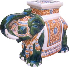 an elephant shaped vase is painted with colorful designs