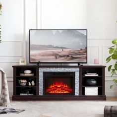 a flat screen tv sitting on top of a wooden stand next to a fire place