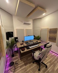 a home recording studio with two monitors and keyboards