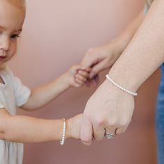 This freshwater pearl bracelet is the perfect gift for any special occasion. It is elegant and classy, featuring freshwater pearls. Whether you’re buying for mommy and me, or your baby girl or toddler, our matching bracelets are the perfect way to show your love. With these timeless pieces, your loved one can look back on these memories for years to come. This pearl bracelet is made with 5mm creamy white freshwater pearls. Being real freshwater pearls they are more sensitive to wear and tear. If Freshwater Pearl Bracelet, White Freshwater Pearl, Creamy White, Matching Bracelets, Diy Beads, Mommy And Me, Pearl Bracelet, Timeless Pieces, Handmade Bracelets