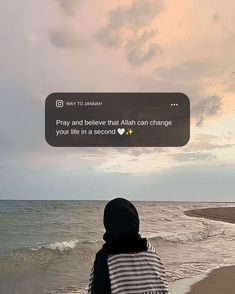 a person sitting on the beach looking out at the ocean with an instagram message above them