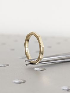 a gold ring sitting on top of a metal table