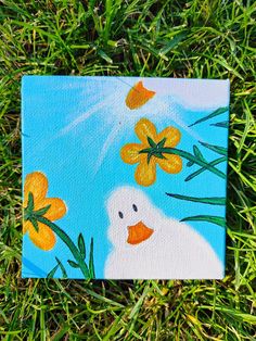 a painting of a duck in the grass with yellow flowers on it's head