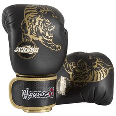 two black and gold boxing gloves with tiger designs