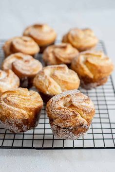 several pastries on a cooling rack with powdered sugar