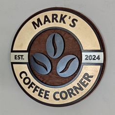 a sign that says mark's coffee corner on the side of a white wall