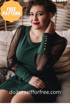 a woman sitting on top of a bed wearing a green dress and holding her hand under her chin