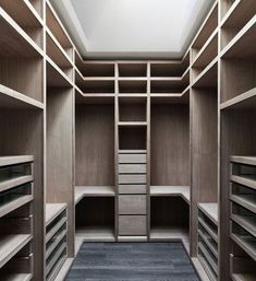 an empty walk in closet with shelves and drawers