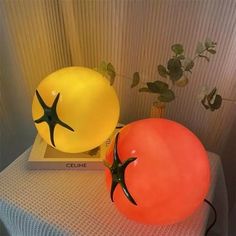 two large tomatoes sitting on top of a table