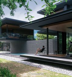 a person sitting on a bench in front of a house